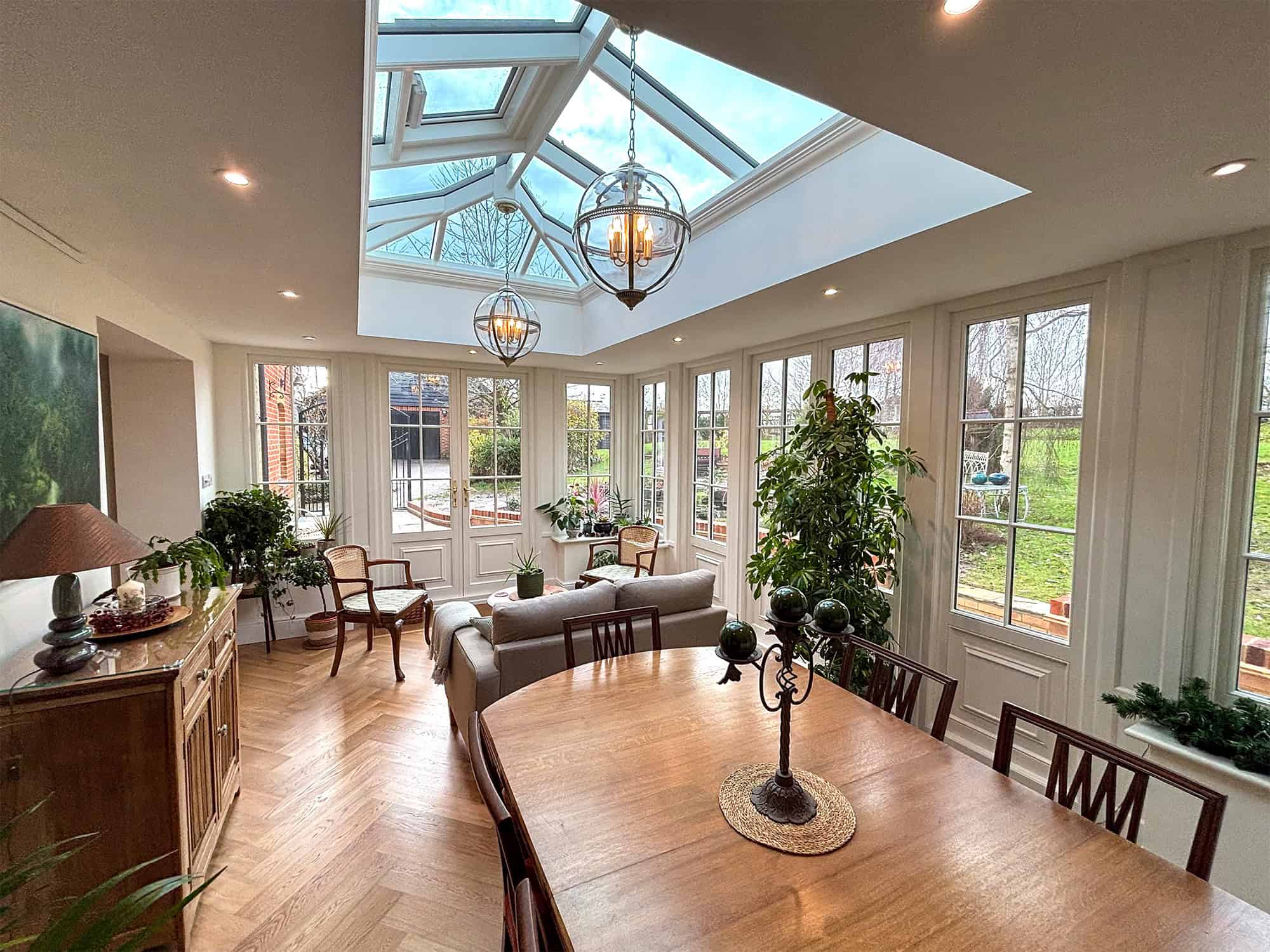 Cottage orangery interior with roof lantern and pendant lights