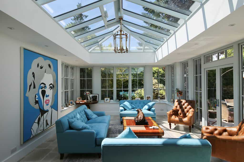Finished Amersham orangery with blue sofas beneath the glazed roof lantern