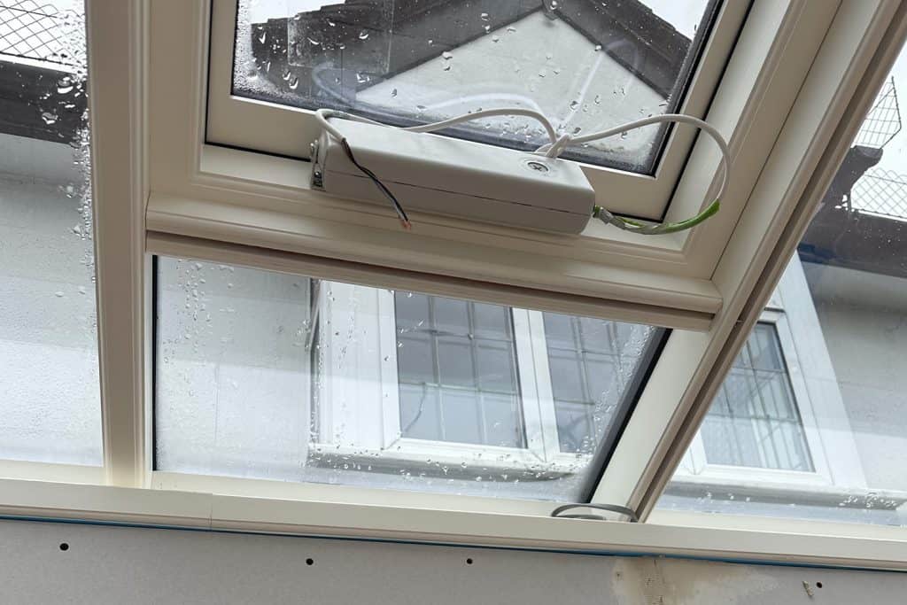 Close-up of the electric roof vent actuator inside the glazed lantern
