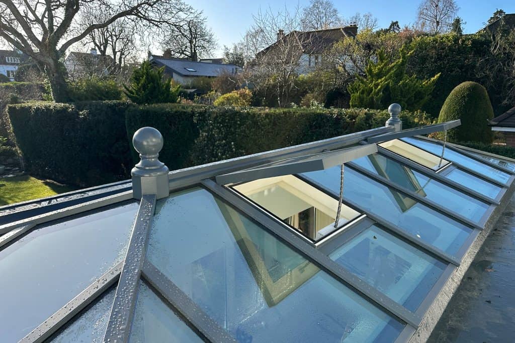 Two open electric roof vents in the glazed orangery lantern
