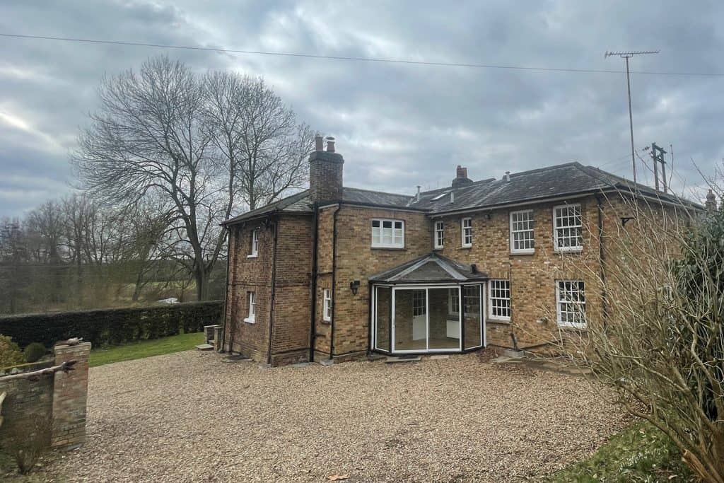 Original small glazed lean-to beside the driveway entrance at a Woodhall Park residence
