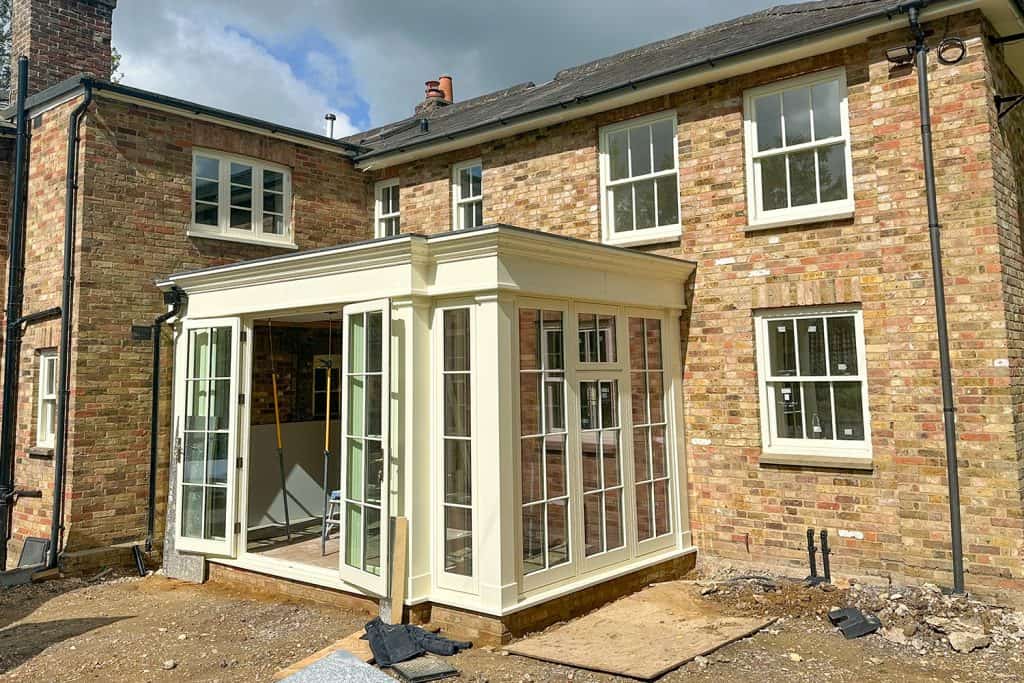 Off-white garden room doors and windows fitted before the external work is complete