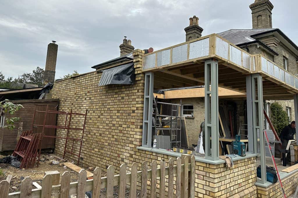 Roof framing and glulam lantern opening beside the Victorian villa