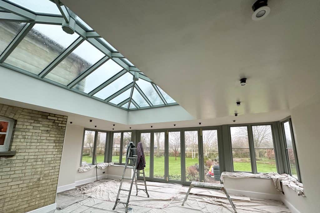 Plastered orangery interior with the original villa brickwork left exposed as a feature