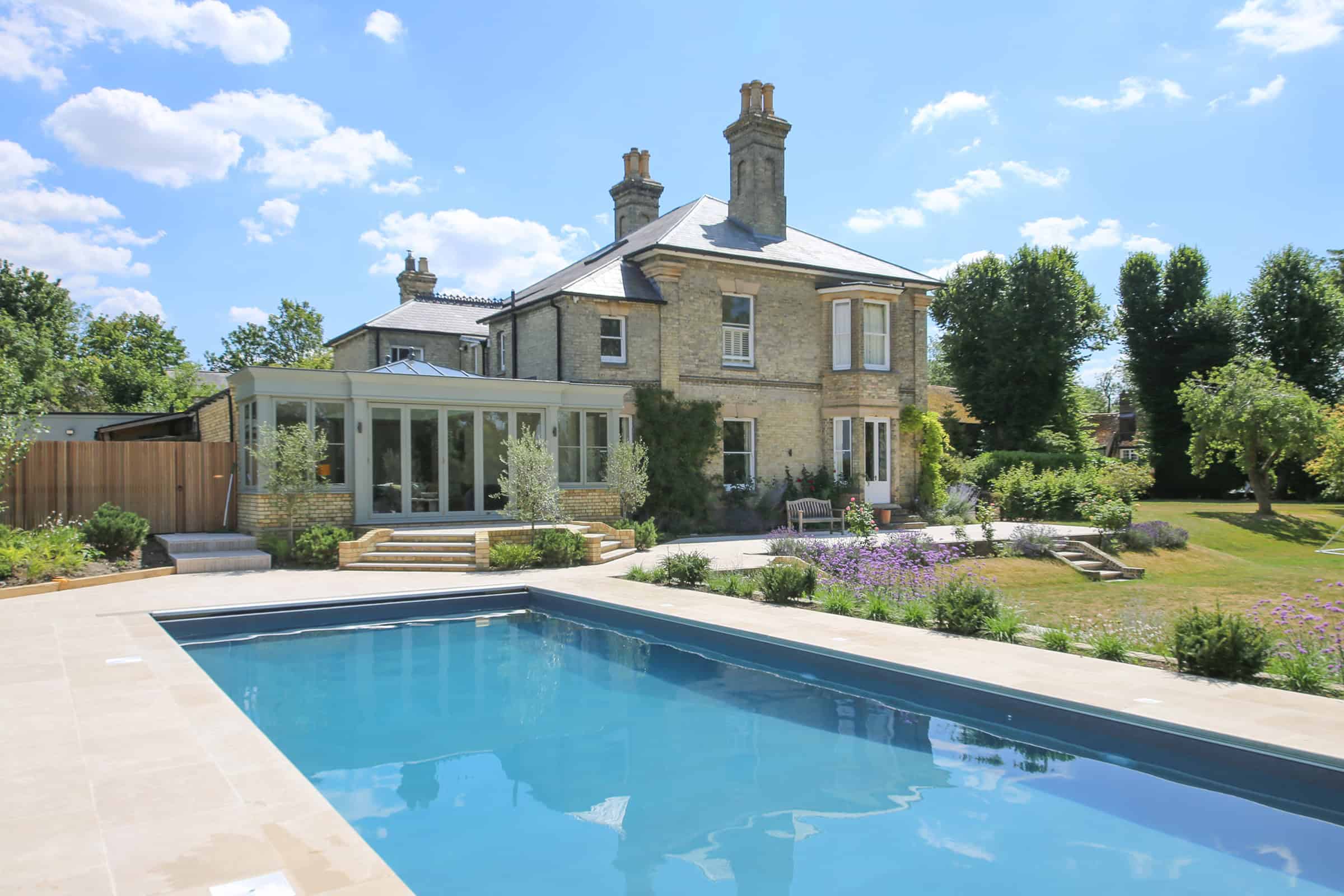 Pastel green orangery added to a Victorian villa in Hertfordshire, overlooking the landscaped garden