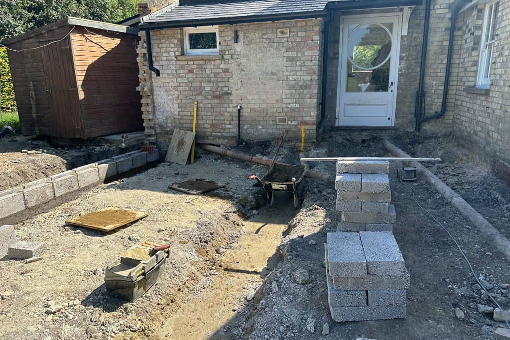 Foundation excavation and drainage work beside the existing house