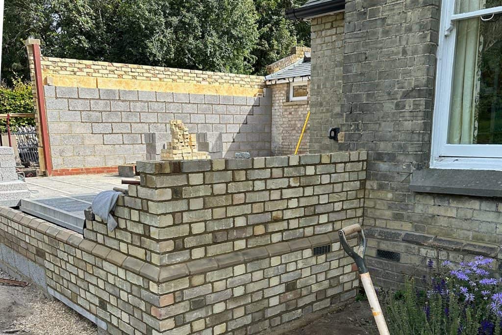 Long flank wall built in brickwork to match the Victorian villa