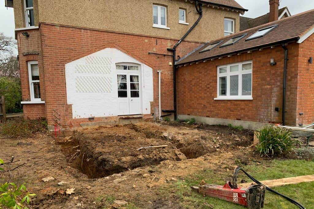 Conservatory removed and new foundation trenches excavated between two parts of the St Albans house