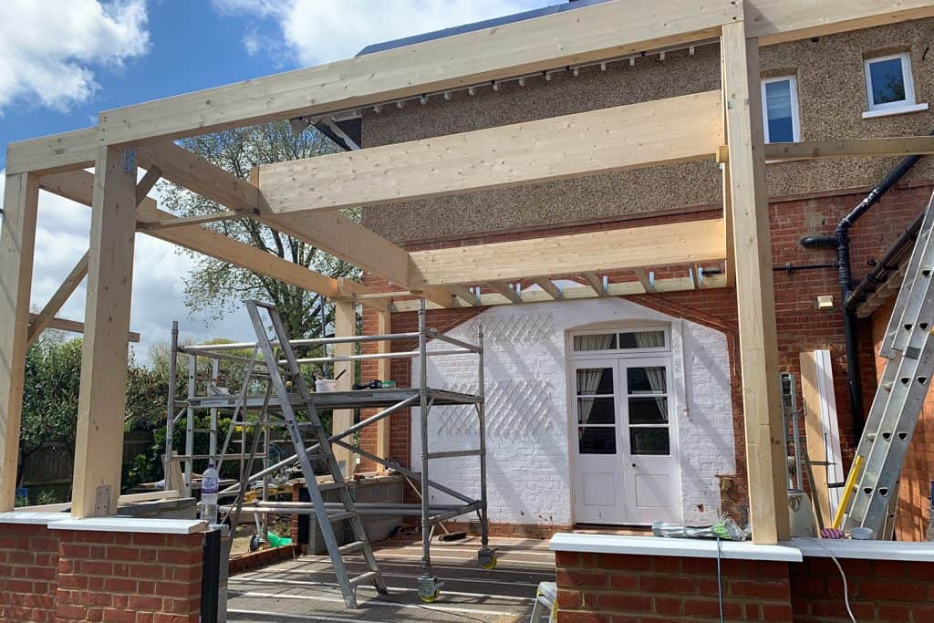 Large glulam beams and timber posts forming the orangery roof and lantern opening