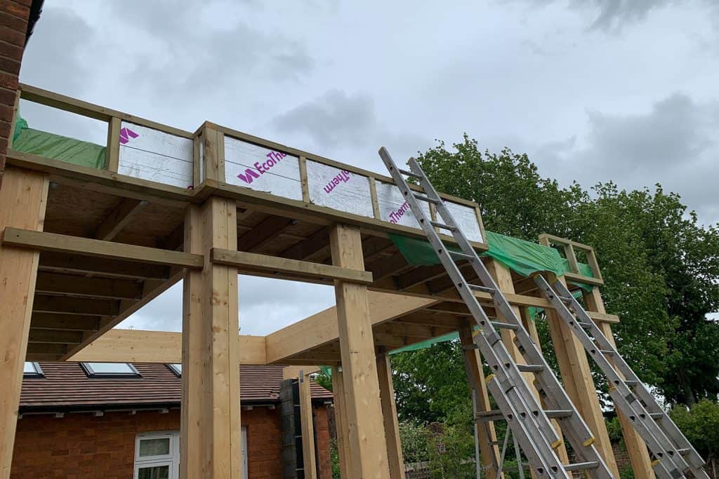 Roof joists and insulation being installed behind the orangery fascia