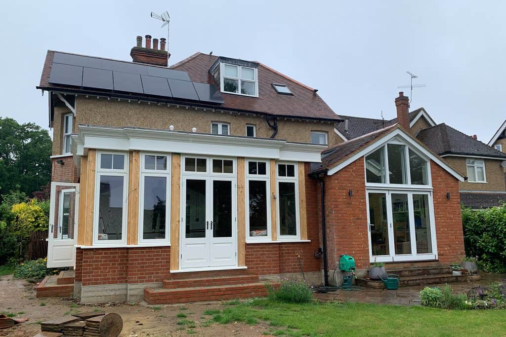 Outside view of the fitted orangery windows, doors and fascia beside the house