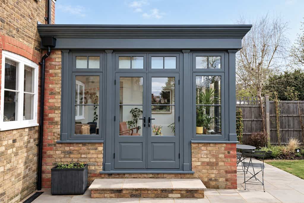 Finished dark grey double doors and windows above yellow stock brickwork