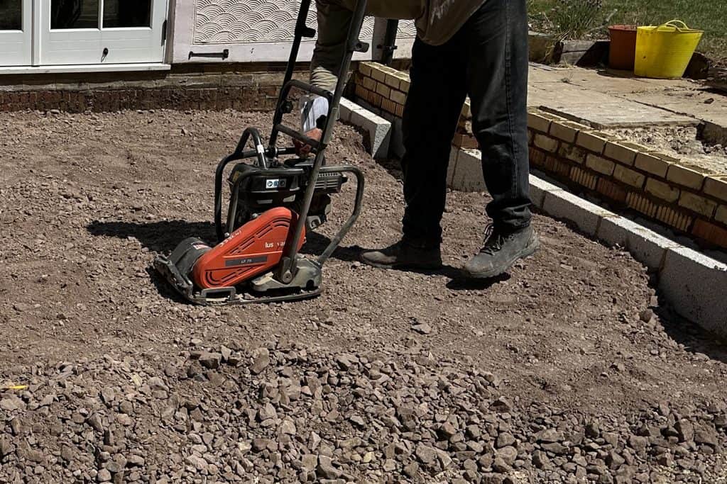 Worker compacting the sub-base for the Cambridgeshire orangery floor
