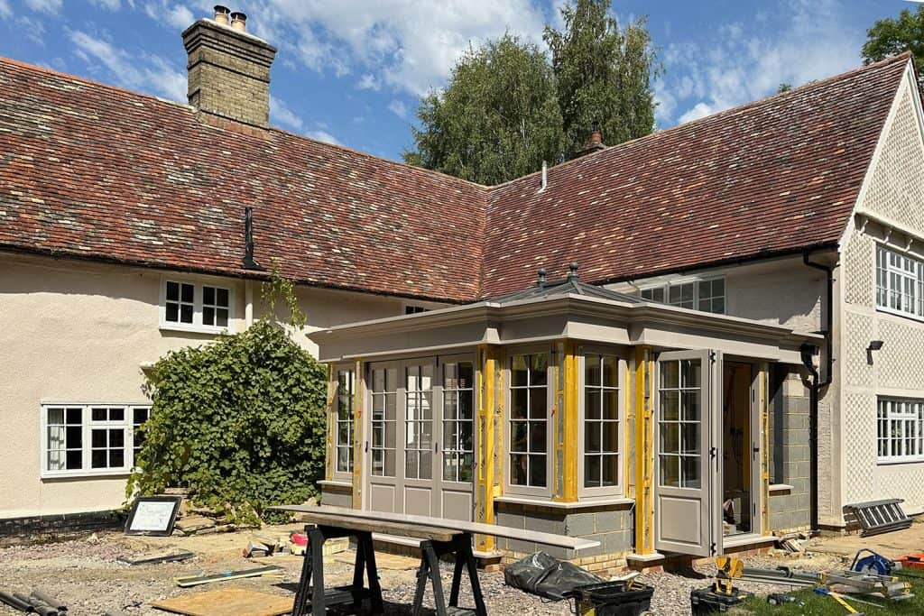 Orangery structure and window frames being fitted to the farmhouse